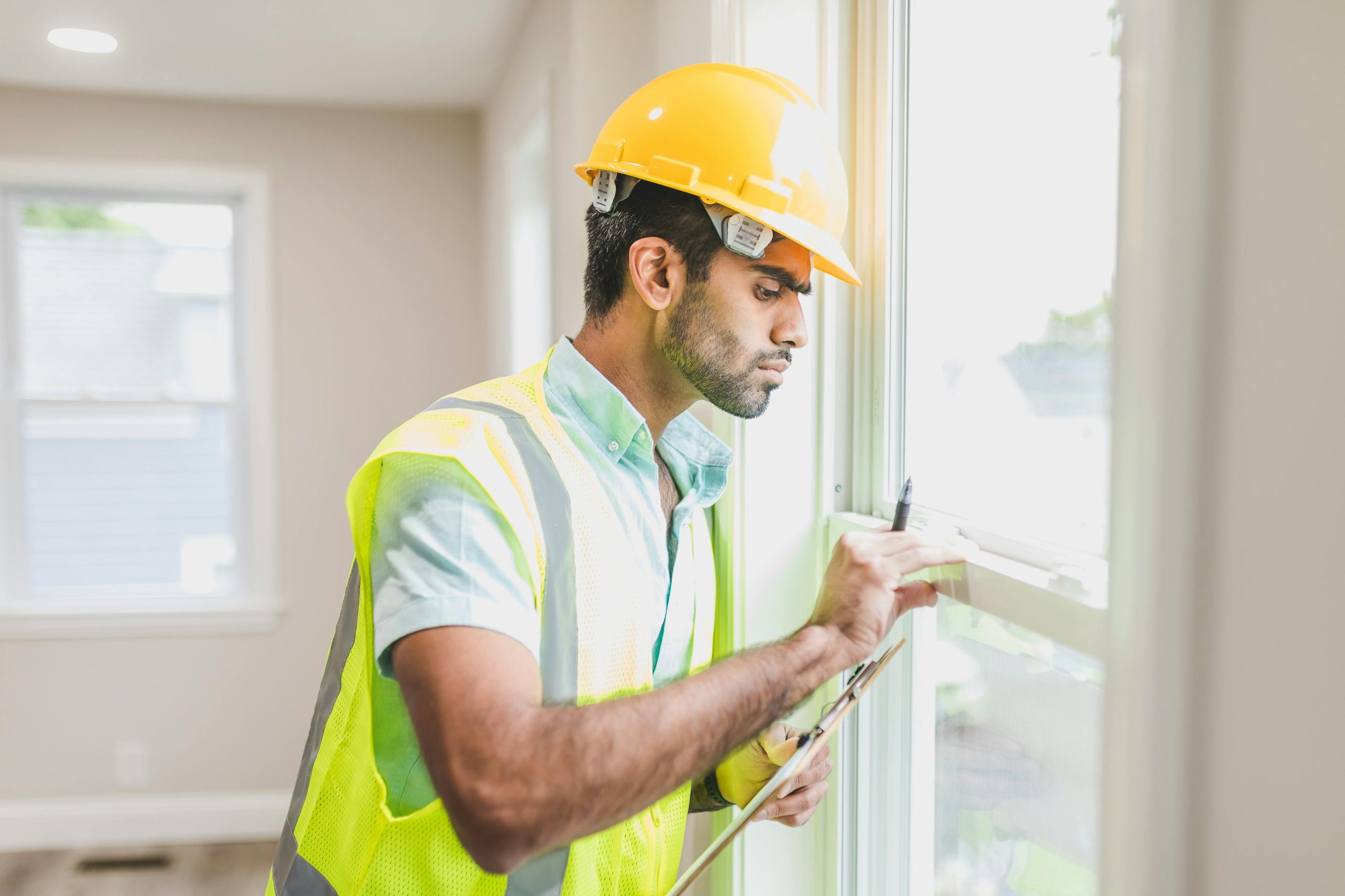 Home foundation safeguards - Construction man looking at windows - Atlantic Foundation